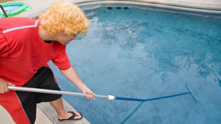 piscineiro limpando piscina